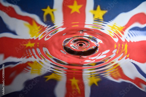 UK Union Jack and the stars of the European Union reflected in a water splash with a single drop of water falling photo