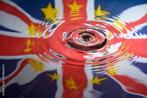 UK Union Jack and the stars of the European Union reflected in a water splash with a single drop of water about to land photo