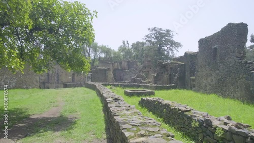 Camera forward view of grounds past the Turkish Baths towards Bakaffa Palace and banqueting hall in the Fasil Ghebbi royal enclosure in Gondar, Ethiopia photo