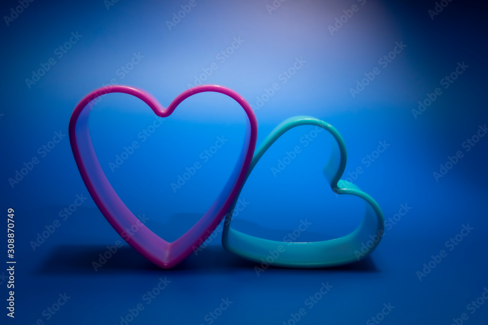 Heart-shaped cookie cutters in blue glow
