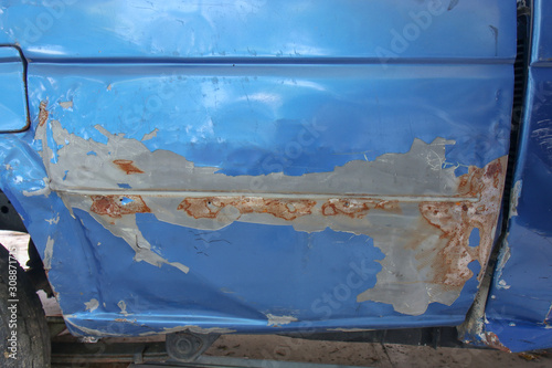 Close-up of old blue car paint broken, crack color of the automobile. Car paint cracks