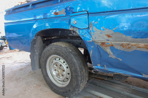 Close-up of old blue car paint broken, crack color of the automobile. Car paint cracks