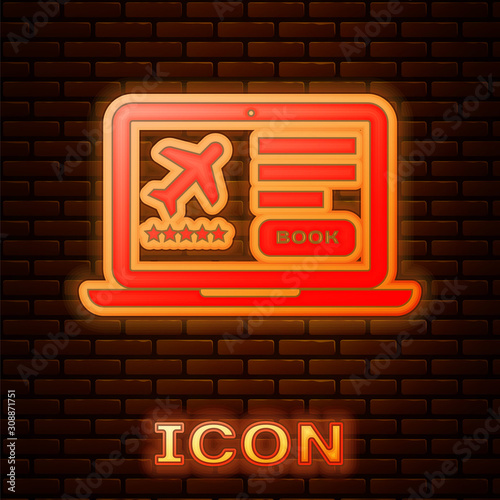 Glowing neon Laptop with electronic boarding pass airline ticket icon isolated on brick wall background. Passenger plane mobile ticket for web and app. Vector Illustration