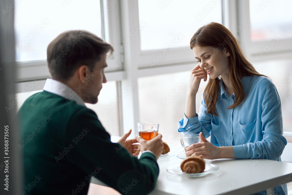 young couple having breakfast in the kitchen young couple having breakfast in the kitchen