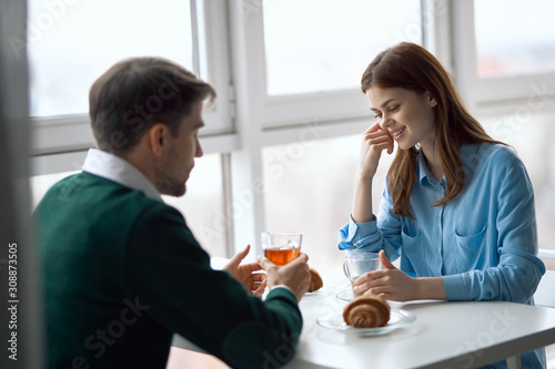 young couple having breakfast in the kitchen