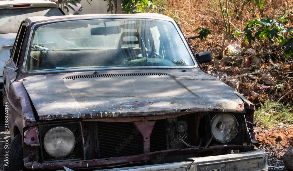 Fototapeta premium abandoned old car on the side of a road