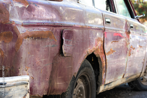 abandoned old car on the side of a road