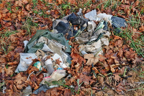 A pile of decayed industrial urban plastic trash left in the forest