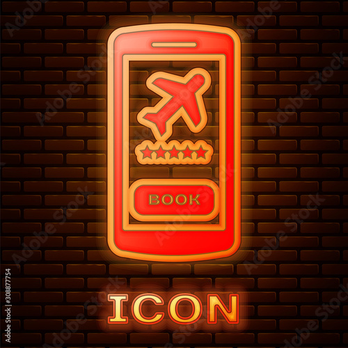 Glowing neon Smartphone with electronic boarding pass airline ticket icon isolated on brick wall background. Passenger plane mobile ticket for web and app. Vector Illustration