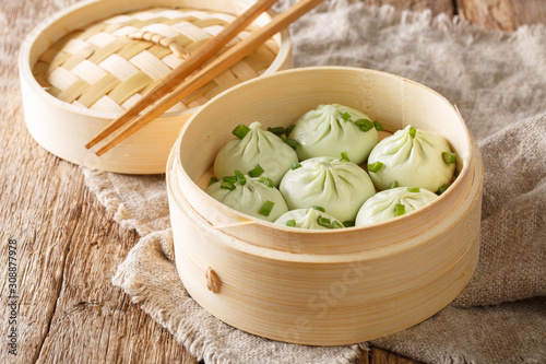 Delicious homemade chinese cuisine Steamed Baozi with bamboo steamer close-up. Horizontal