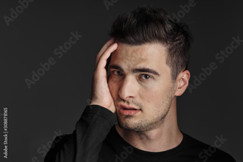 portrait of young man isolated on black background