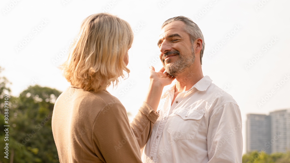 Portrait of senior caucasian couple holding each other feeling loved and happy in the afternoon sun, elderly couple anniversary, elderly togetherness, happy retirement,romantic couple, love expression Portrait of senior caucasian couple holding each other feeling loved and happy in the afternoon sun, elderly couple anniversary, elderly togetherness, happy retirement,romantic couple, love expression
