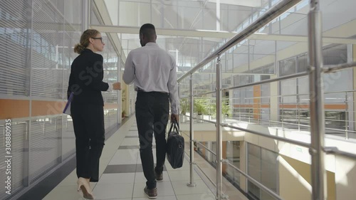 Business people walking in the office corridor