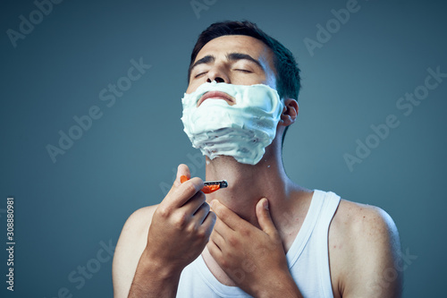 young handsome man shaving photo