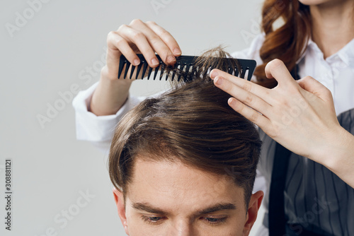 hairdresser with scissors and comb