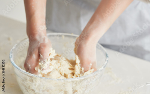 woman hands mixing dough on wooden table