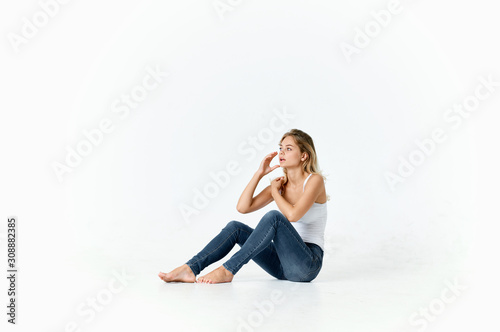 young woman sitting on the floor isolated on white