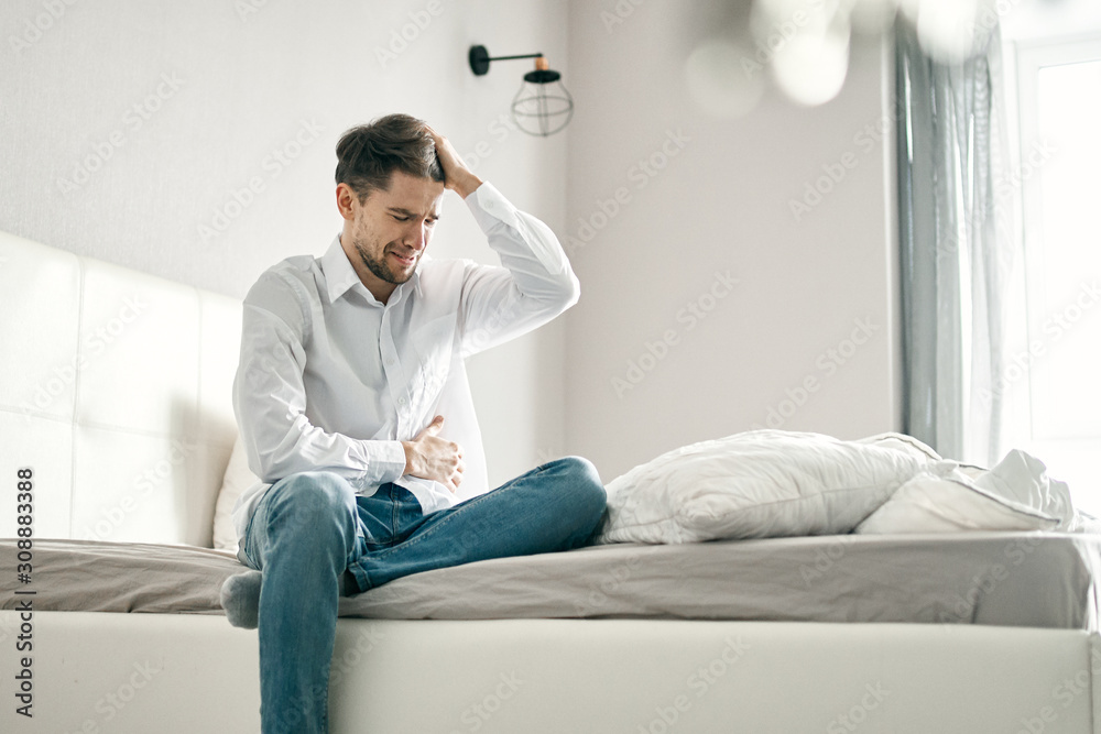man sitting on sofa at home man sitting on sofa at home