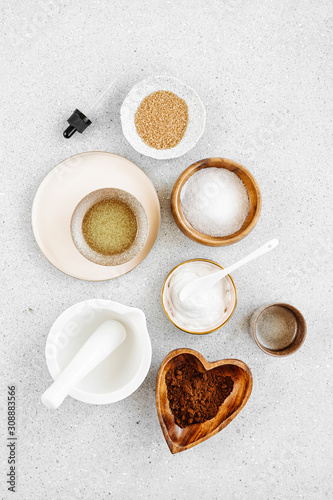 Beauty treatment ingredients for making homemade skin care cosmetic mask. Various bowl with clay, cream, essential oil and natural ingredients on white table background. Organic spa cosmetic products