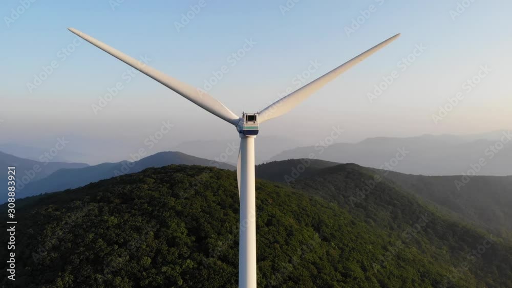 Drone shots of wind generators on top of a mountain