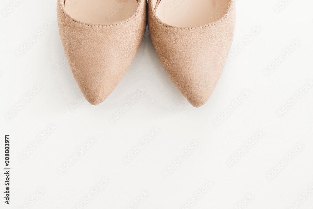 The details of the wedding day. Bride's shoes on a light background The details of the wedding day. Bride's shoes on a light background