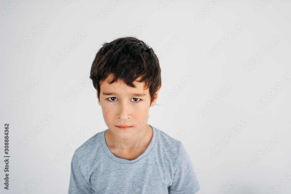 Frustrated Moody tween boy looking at camera on white background Frustrated Moody tween boy looking at camera on white background