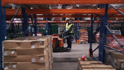 workers moves on a forklift in a warehouse