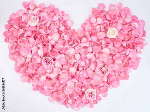 Heart symbol made of pink rose petals.