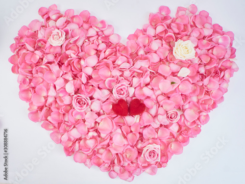 Heart symbol made of pink rose petals.