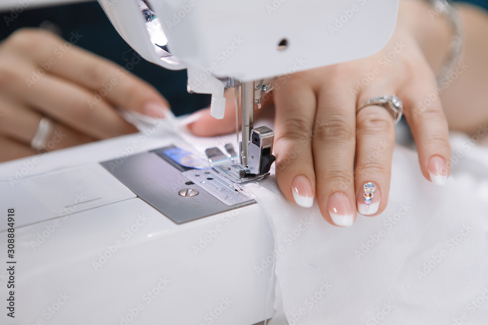Hands of Woman with sewing-machine.
