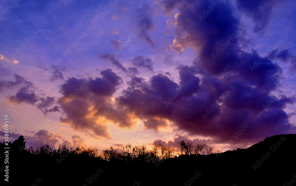 Fototapeta premium Dramatic twilight sky with silhouette landscape