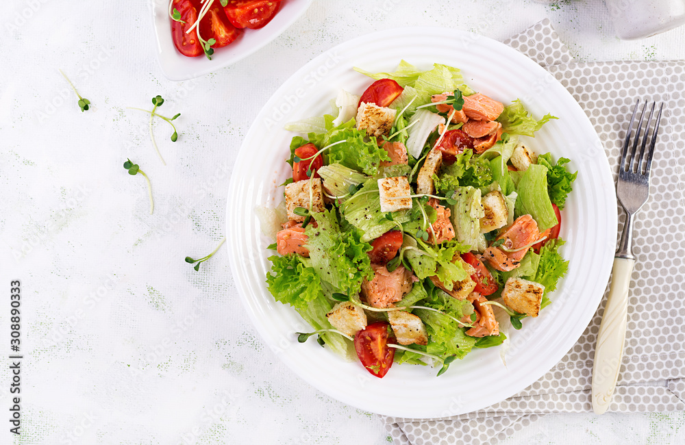 Caesar Salad with Salmon. Fish menu. Seafood - salmon. Top view, overhead, copy space Caesar Salad with Salmon. Fish menu. Seafood - salmon. Top view, overhead, copy space