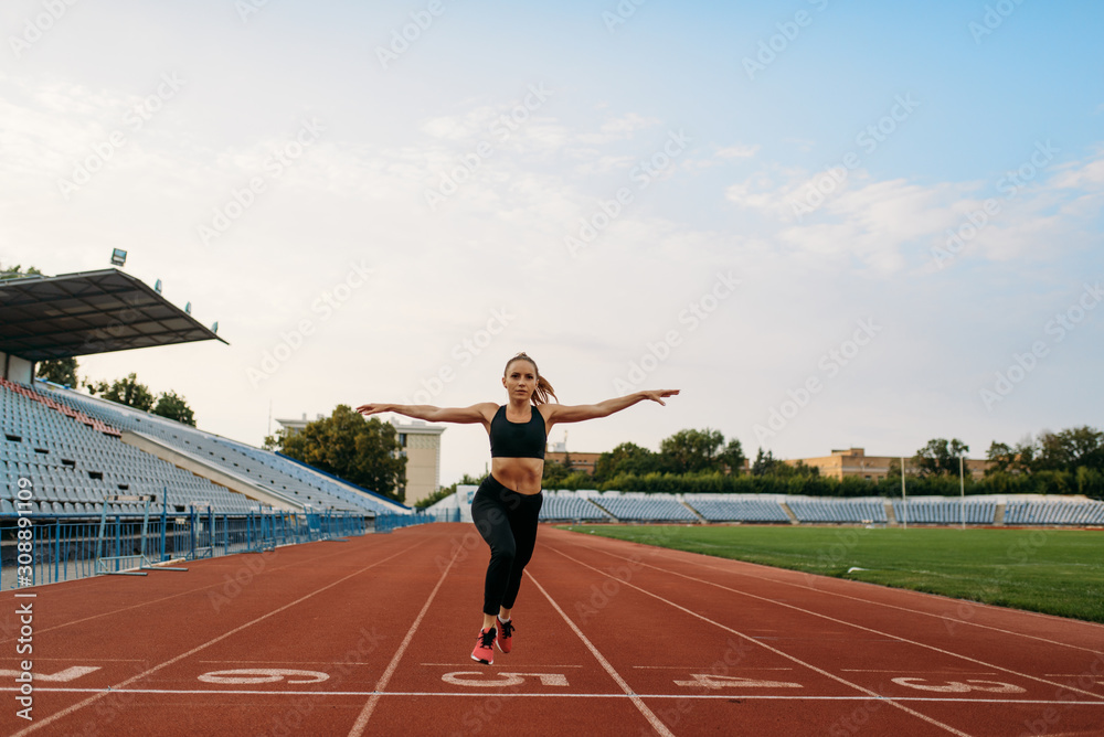 Fototapeta premium Female jogger in sportswear crosses finish line