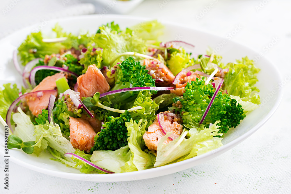 Salad of baked fish salmon, broccoli, lettuce, red onion and dressing. Fish menu. Seafood - salmon. Salad of baked fish salmon, broccoli, lettuce, red onion and dressing. Fish menu. Seafood - salmon.