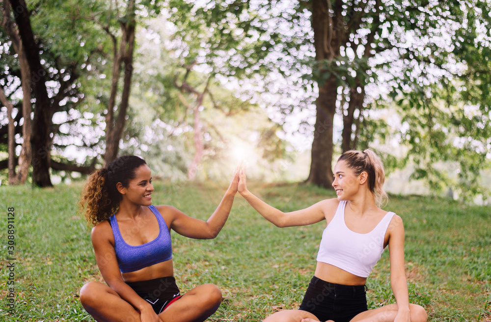 Fototapeta premium Young woman raise up hands and relax at outdoor in the morning together,Happy and smiling,Positive thinking,Healthy and lifestyle concept