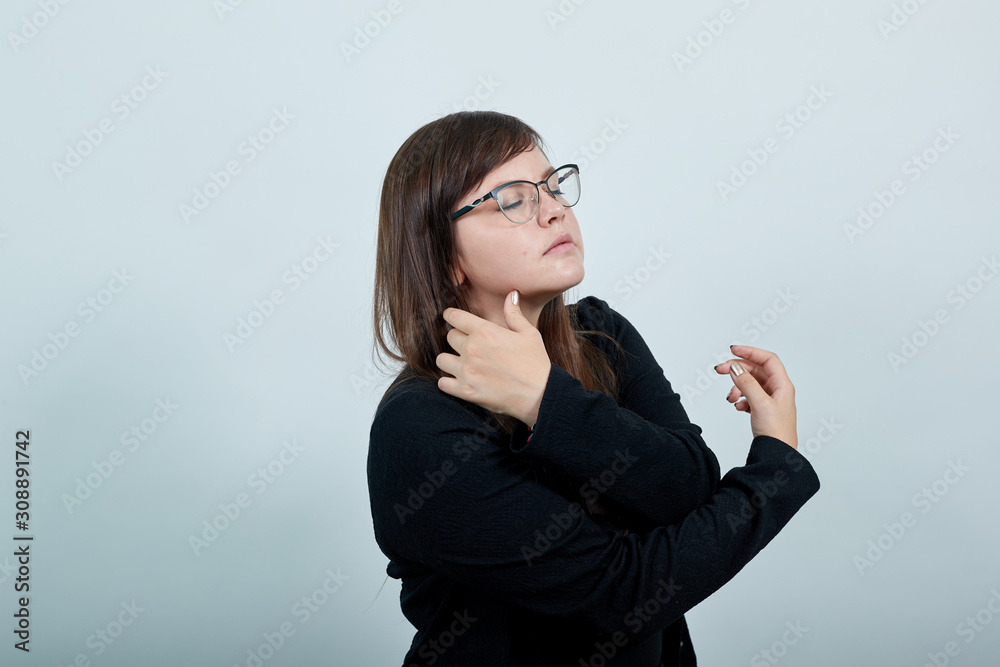 Pretty young caucasian woman over isolated gray wall holding hand crossed, hugging herself with closed eyes, relax wearing funny clothes, looking nice Pretty young caucasian woman over isolated gray wall holding hand crossed, hugging herself with closed eyes, relax wearing funny clothes, looking nice