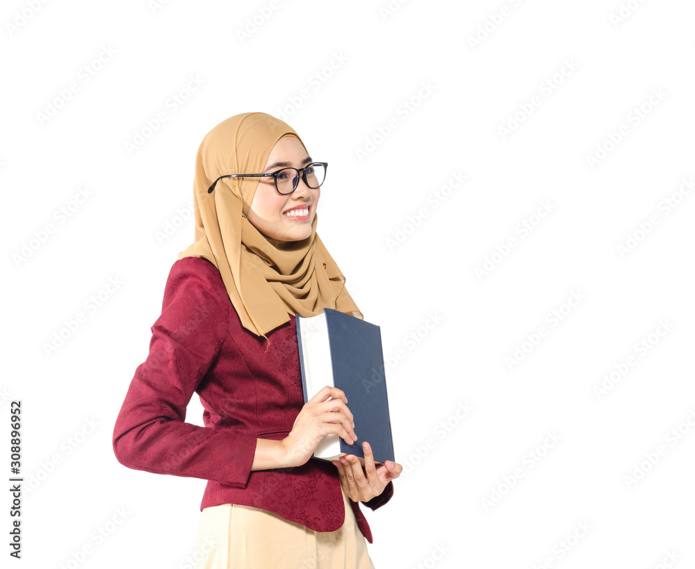 Confident young woman with hijab standing and holding book on white background. Confident young woman with hijab standing and holding book on white background.