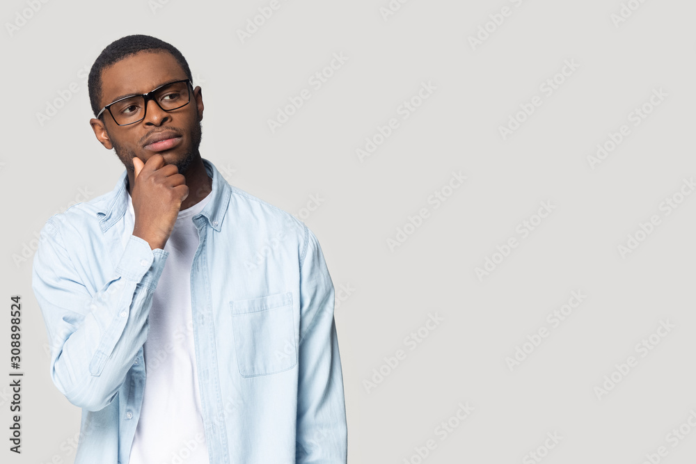 Thoughtful young african american guy looking at blank copy space. Thoughtful young african american guy looking at blank copy space.