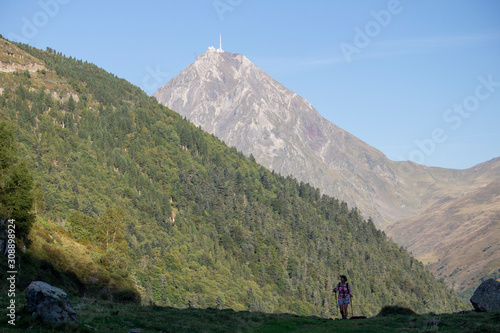 Hiker in the Pyrenees under the Col du Tourmalet and the Pic du Midi de Bigorre photo