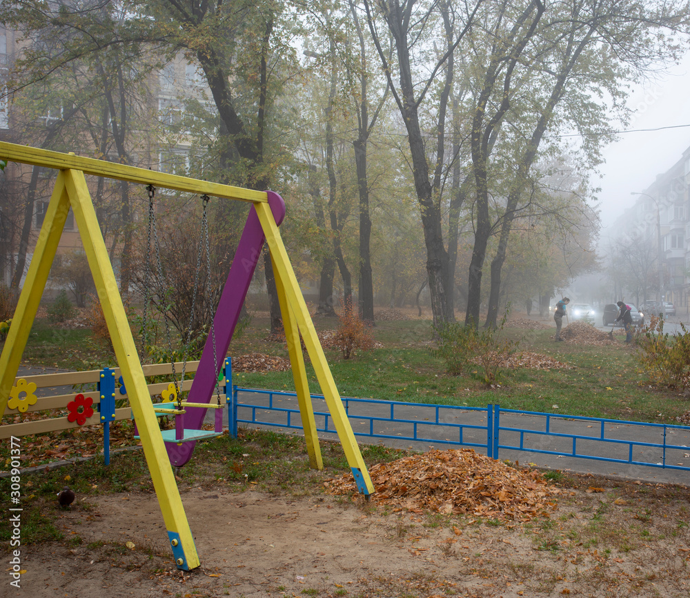 Morning fog and a swing in a city park Morning fog and a swing in a city park