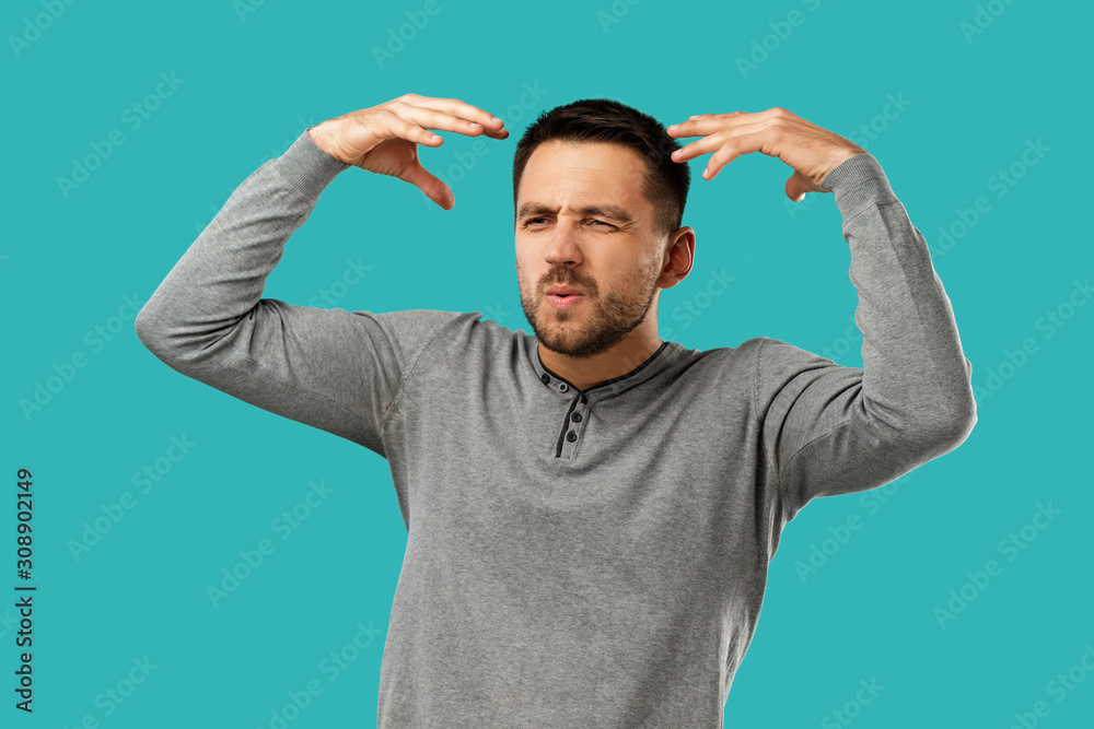 Fototapeta premium portrait of furious enraged bearded man shouting and screaming isolated on blue background