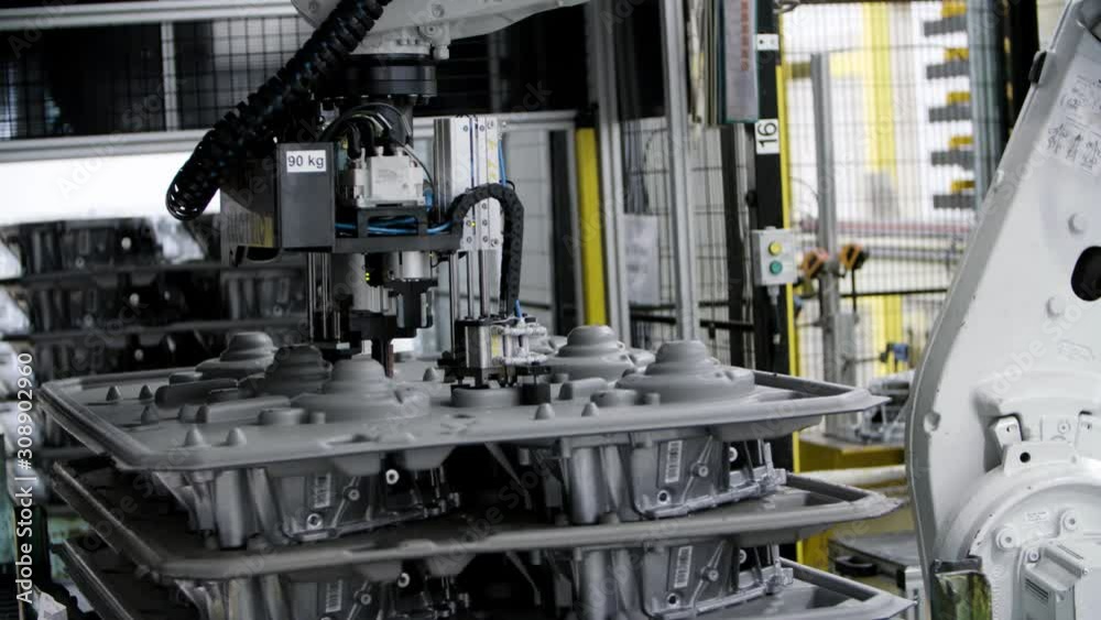 Car engine assembly on the production line inside an automobile manufacturing plant