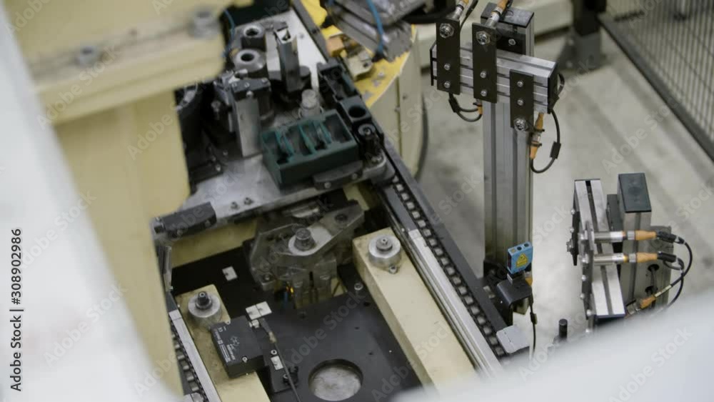 Car engine assembly on the production line inside an automobile manufacturing plant Car engine assembly on the production line inside an automobile manufacturing plant