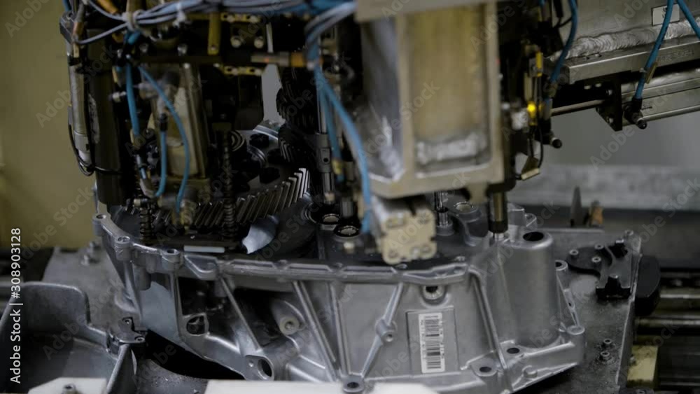 Car engine assembly on the production line inside an automobile manufacturing plant Car engine assembly on the production line inside an automobile manufacturing plant