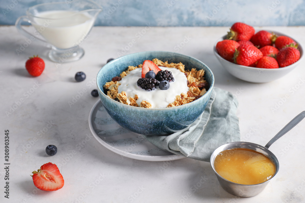 Tasty granola with yogurt in bowl on table Tasty granola with yogurt in bowl on table