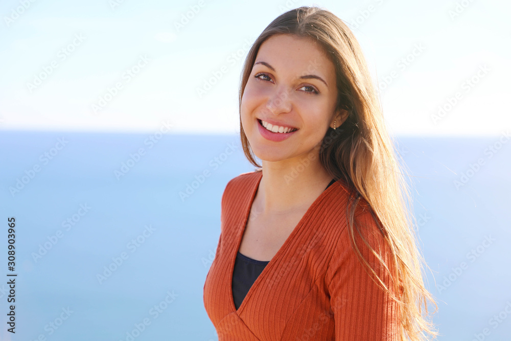 Smiling beauty healthy woman with blue sea on background Smiling beauty healthy woman with blue sea on background
