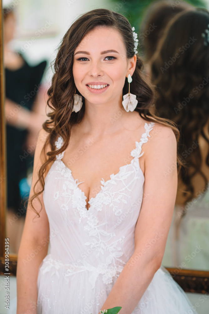 Fototapeta premium Wedding day. Portrait of beautiful bride with bouquet