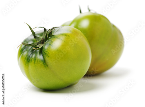 fresh green tomato isolated on white background photo