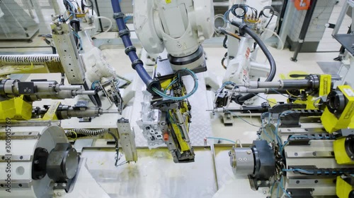 Car engine assembly on the production line inside an automobile manufacturing plant