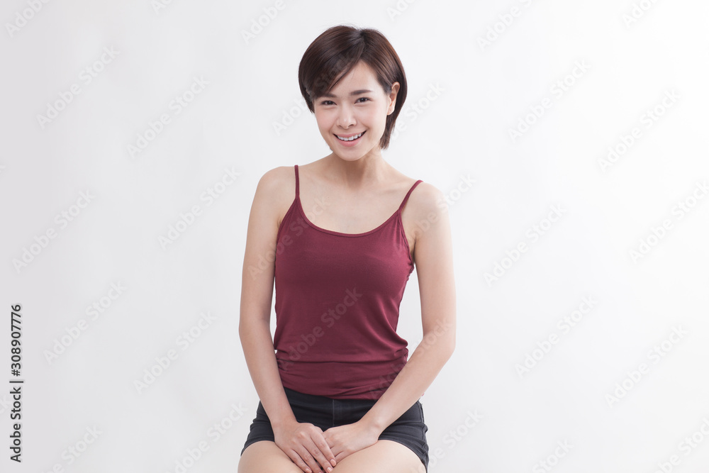 Young beautiful Asian female model on the white background Young beautiful Asian female model on the white background